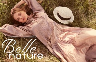 Image of model Elena Matei lying in the grass